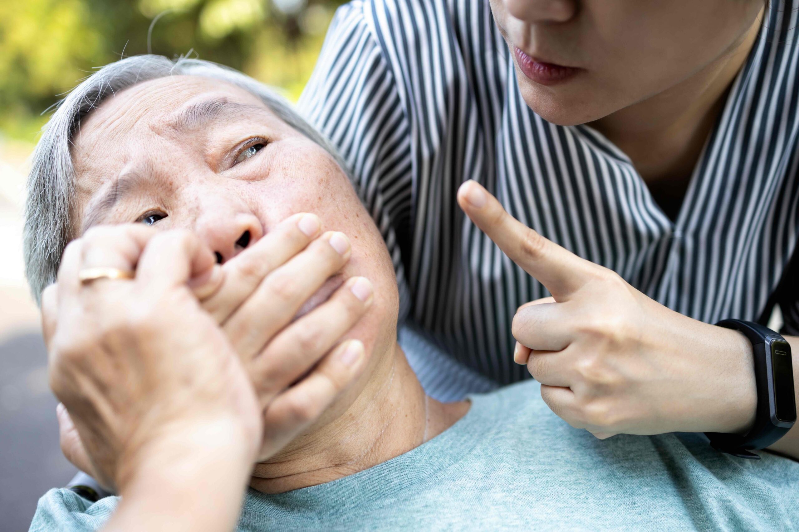 Elderly woman being intimidated by a caregiver, illustrating power of attorney abuse and undue influence